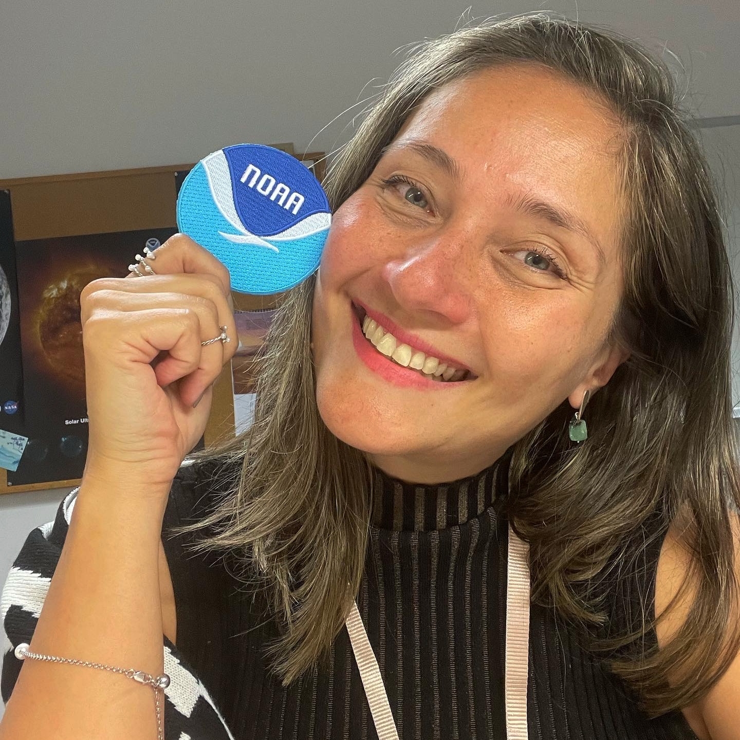 NCEI’s  Alessandra (Ale) Pacini posing with a NOAA patch. 