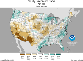 Map of the U.S. showing divisional precipitation ranks for April 2023 in shades of green (wetter) and brown (drier).