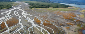 Braided streams of the Grewingk Glacier River in Alaska. Retreating glaciers carry large volumes of sediment, producing braided streams with multiple channels.