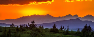 Photo of a sunset over mountains