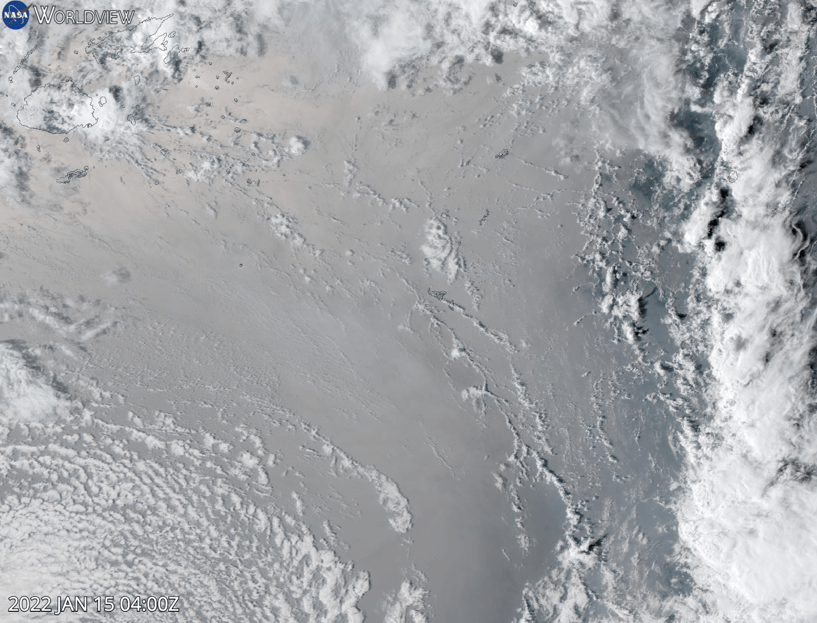 Animation of the eruption of the Hunga Tonga-Hunga Ha'apai volcano captured by the GOES-17 satellite. An aerial view of clouds swirl in the background while a large plume of ash and dust expands rapidly over the location of the volcano.