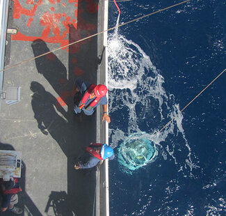 Photo of CTD instrument deployment in ocean
