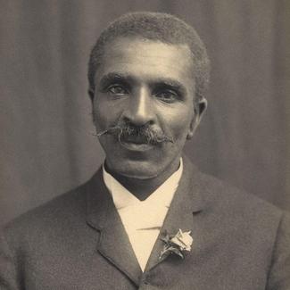 A black and white photo of George Washington Carver in 1910.