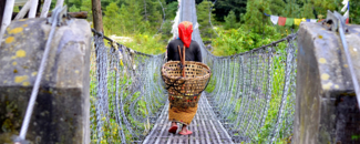 Woman crossing a bridge in Nepal